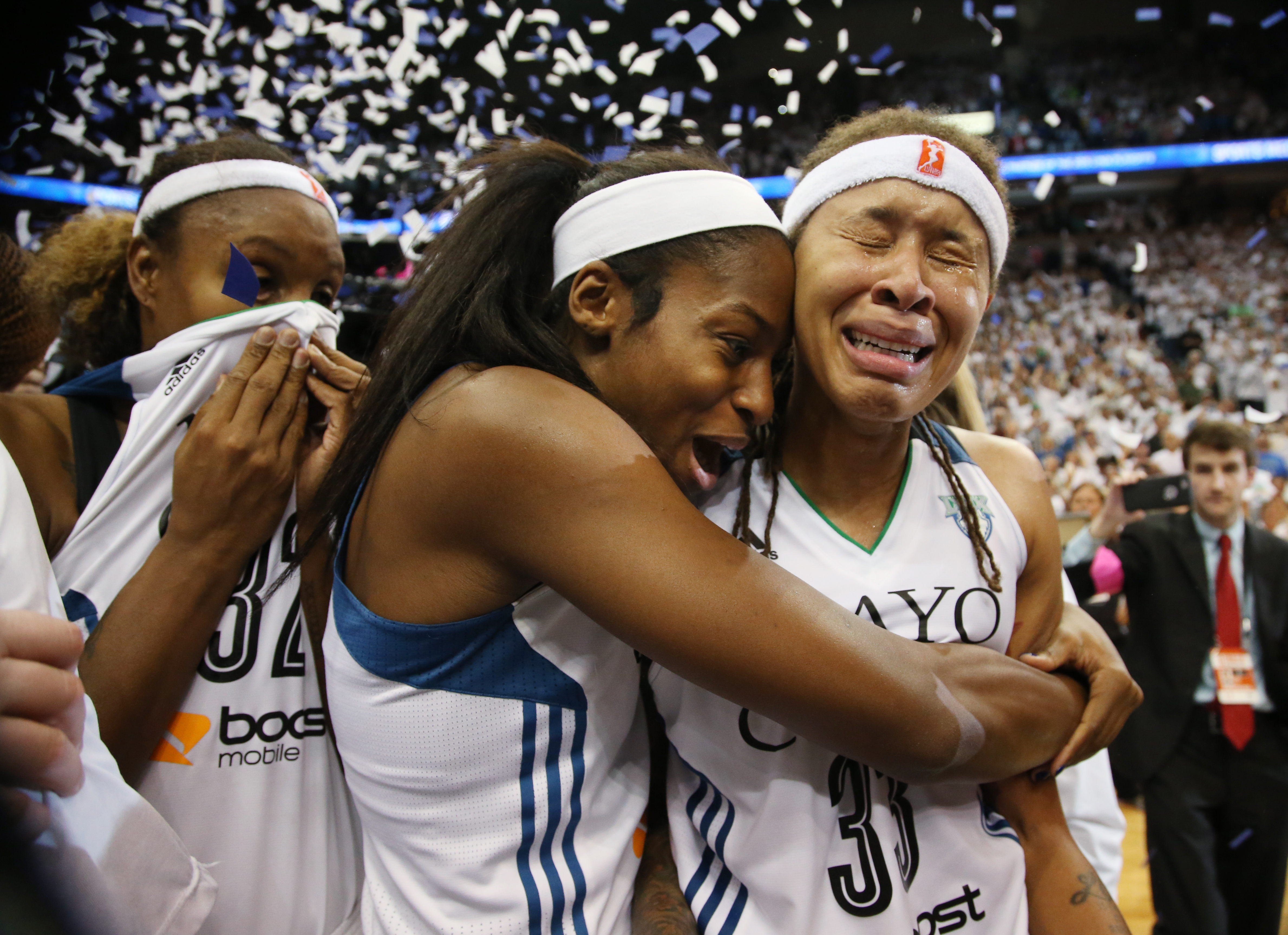 Minnesota Lynx guard Seimone Augustus (33), right, and Minnesota Lynx forward Devereaux Peters (14) celebrate winning the WNBA title.   ] (KYNDELL HARKNESS/STAR TRIBUNE) kyndell.harkness@startribune.com  Game 5 of the WNBA finals Lynx vs Indiana at the Target Center in Minneapolis, Min., Wednesday October 14,  2015. ORG XMIT: MIN1510142135070441