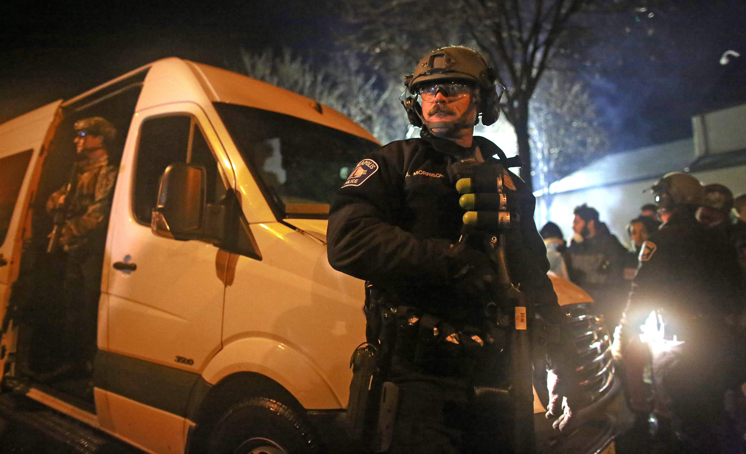 Police in riot gear watched the crowd of protesters after they drove near the front of the Minneapolis Fourth Precinct ] (KYNDELL HARKNESS/STAR TRIBUNE) kyndell.harkness@startribune.com Black Lives Matter protested in front of Minneapolis Fourth Precinct in Minneapolis Min., Wednesday November 18, 2015. ORG XMIT: MIN1511182040500681
