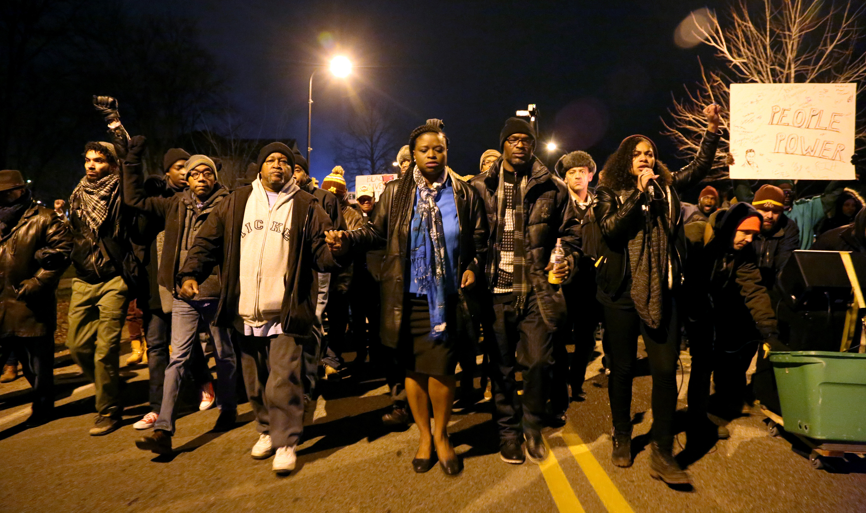 Demonstrators outside the Minneapolis Police Department's 4th Precinct split off and walk to the site where Jamar Clark was shot by police, on Friday, Nov. 20, 2015. (Kyndell Harkness/Minneapolis Star Tribune/TNS) ORG XMIT: 1176971